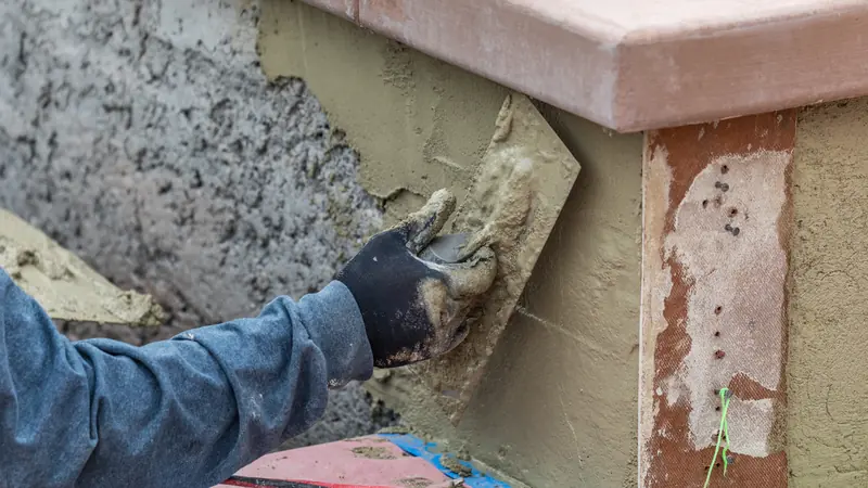 Two-coat stucco applied over a concrete block courtyard wall in Washington County